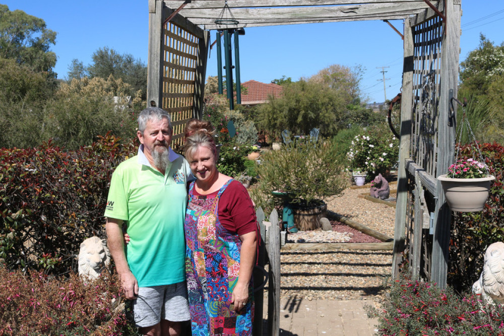 Gerard and Annette Kingsford stand in front of their beautifully arranged native garden.