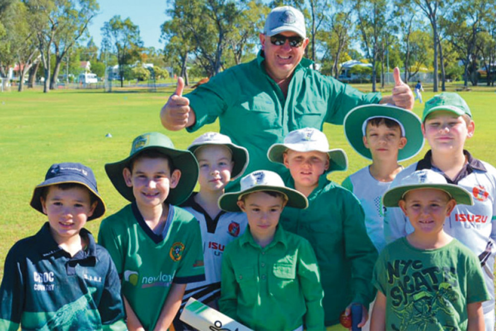 Junior Cricket players turn green for mental health awareness.