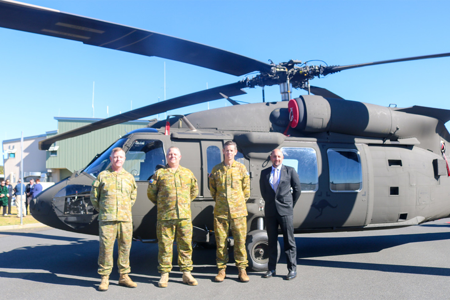 Lieutenant Colonel Duncan Flindle (Commandant, Swartz Barracks Oakey Army Aviation Training Centre), Major General David Hafner AM CSC (Commander, Australian Army Aviation), Major General Jeremy King (Head, Joint Aviation Systems Division CASG), Rodahn Gibbon (Program Manager, Black Hawk Support, Lockheed Martin Australia) stand in front of the aircraft they worked hard to bring to Oakey.