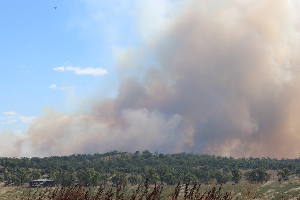 Smoke emanating from the Old Talgai fire was visible for miles around, this shot captured on Ryeford Pratten Road at Sandy Camp. A water bomber can be seen in the top left.