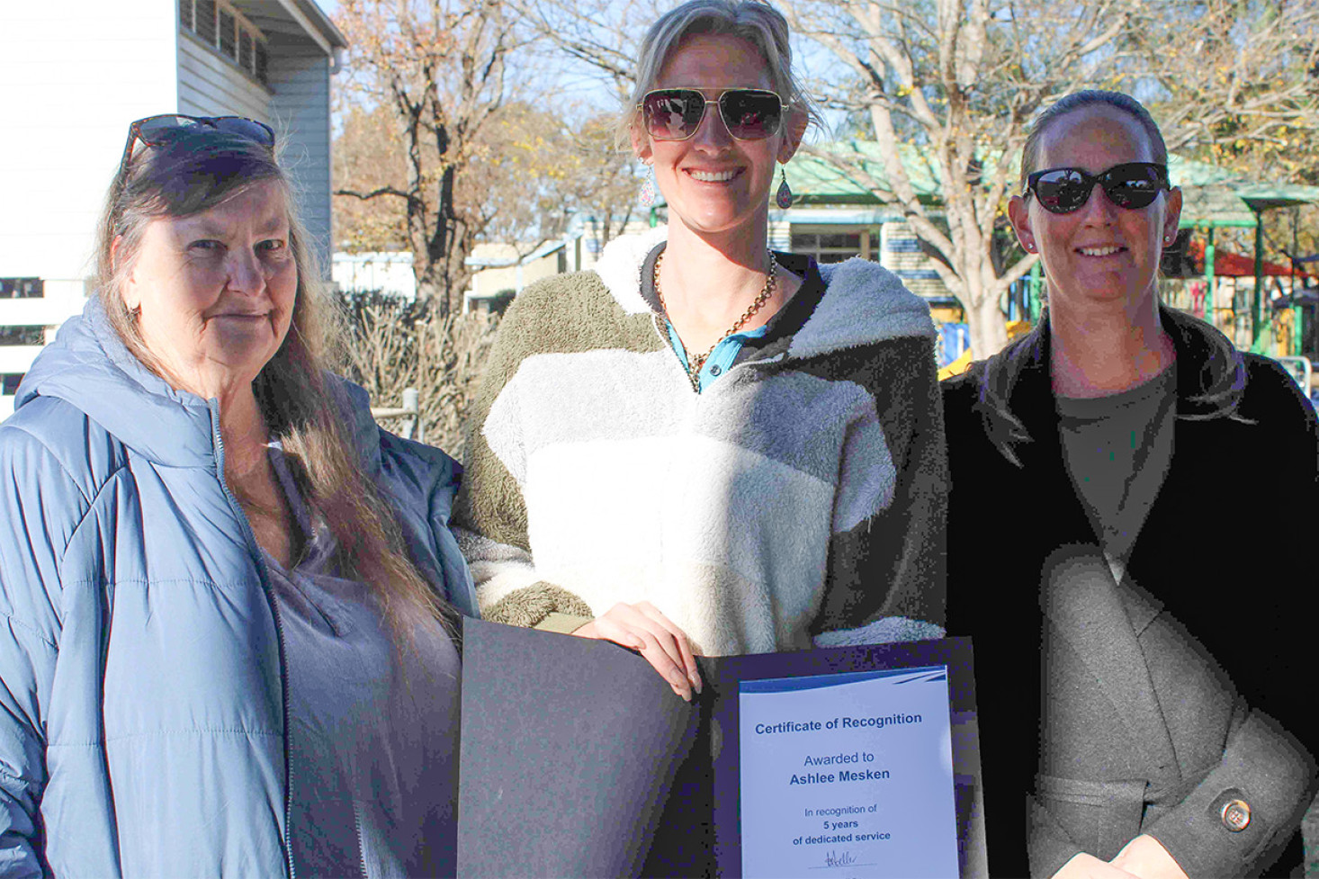 Cambooya State School crossing supervisor Ashlee Mesken (centre), pictured alongside her colleagues Marg and Veronica, has been recognised for her dedication to the school community over the past five years.