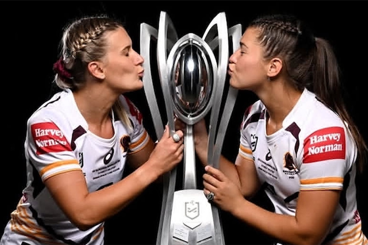 Cousins Shenae Ciesiolka and Jada Ferguson of Westbrook kiss the NRLW premiership trophy. Photo, Gregg Porteous