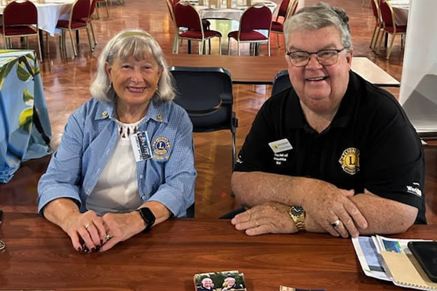 Lions Thelma McKeon and Derek Tuffield OAM at the Club’s stall during the Symposium.