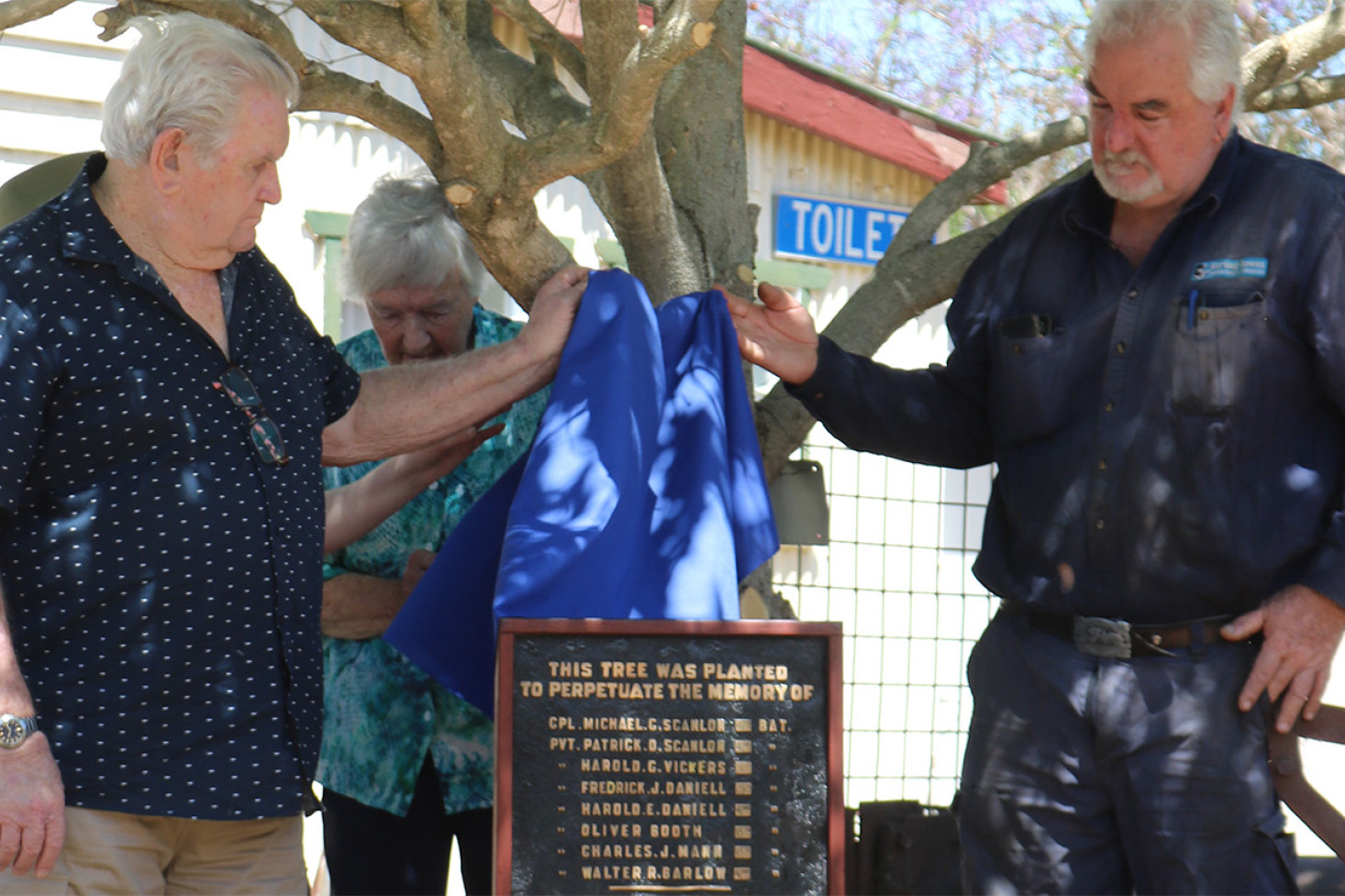 Lifting the veil on the refurbished World War I memorial plaque, Robert Trott and Gary Mann, relatives of Charles Mann who was killed in action at ANZAC Cove on 20th October, 1917.