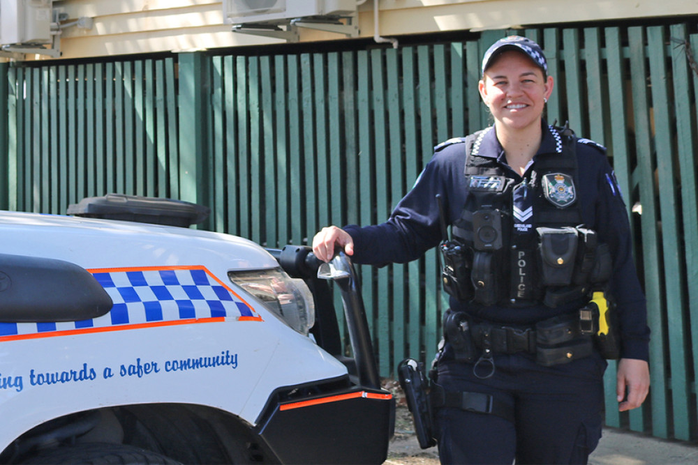 Senior Constable Courtney Holmwood stands in front of her new vehicle.