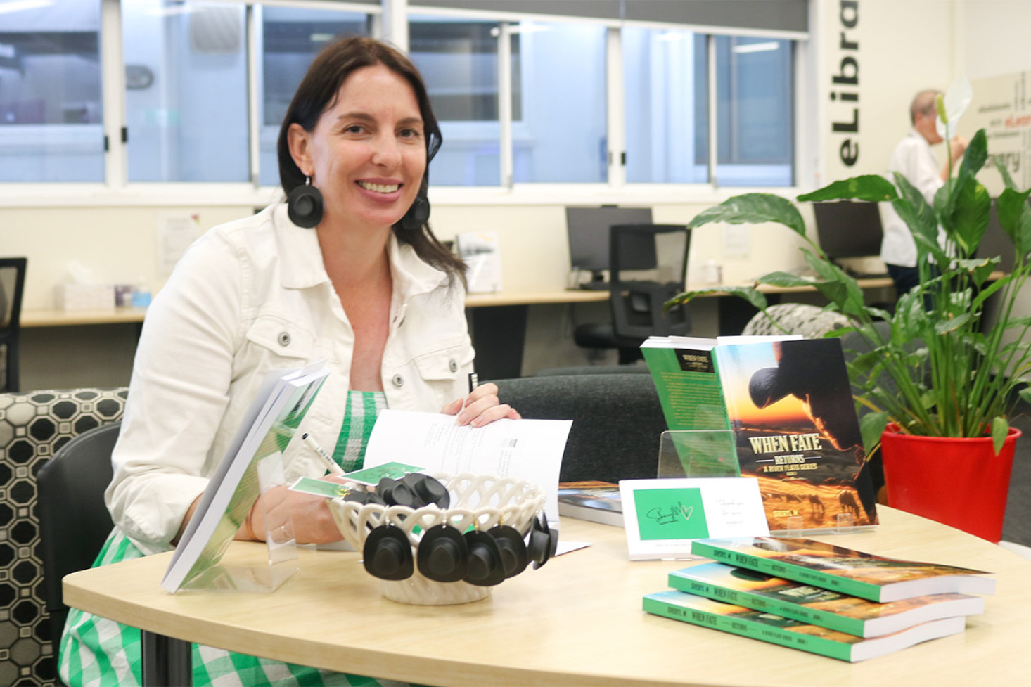 Author Sheryl M with her new book and merchandise at the local launch at the Oakey Library.