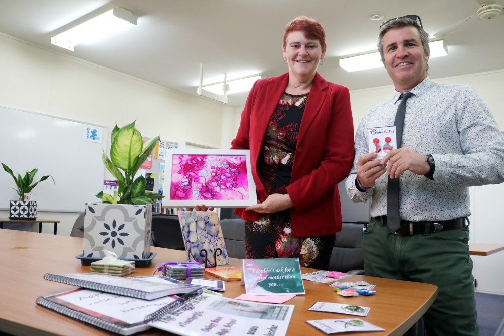 OSHOBA Social Enterprise program coordinator Terri Delander-Curle and principal Danny Keenan show off some of the items made by the Oakey students.