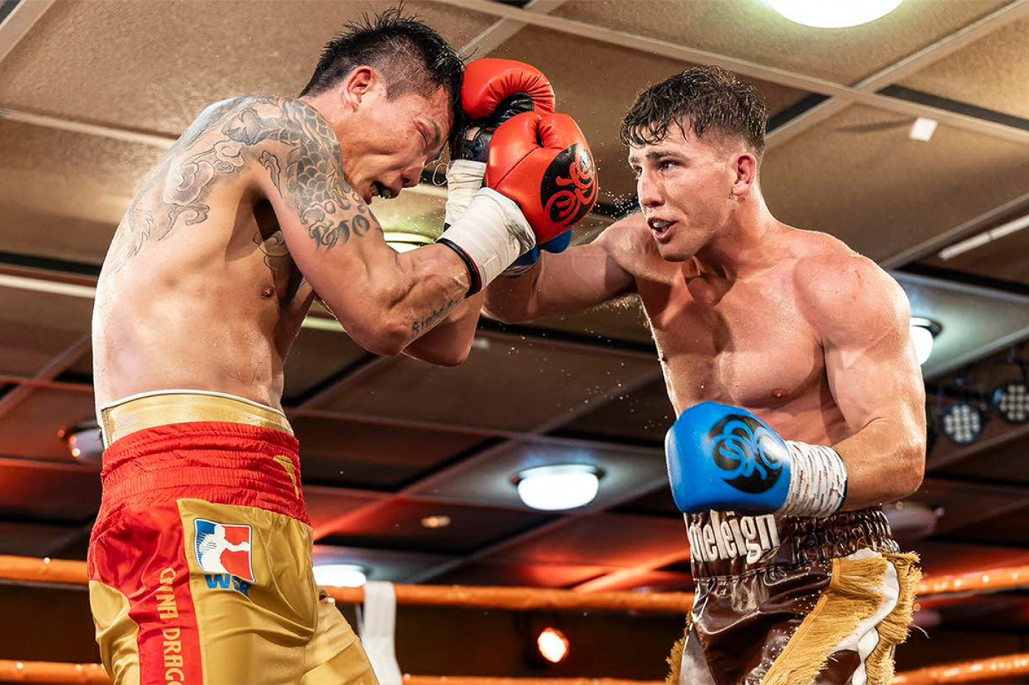 Stoneleigh lands a heavy blow on Yangcheng in their WBC Australasia welterweight title fight on Saturday. Photo, Darren Burns