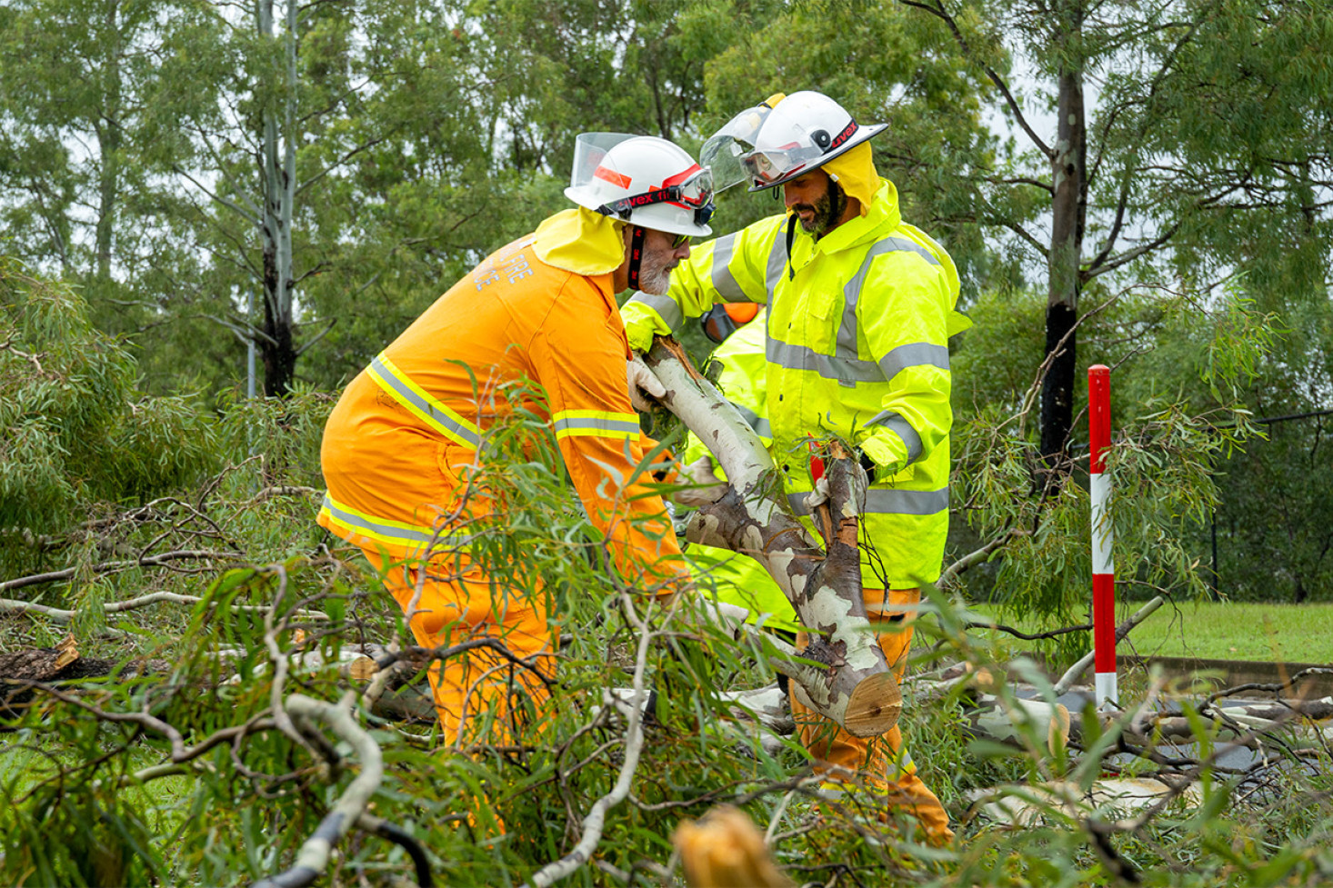 Emergency workers help to clear debris off a Gold Coast road. Photo, Queensland Fire Department