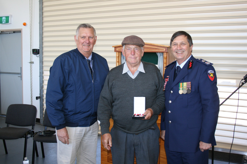 Don Breeze (centre), receiving a Diligent and Ethical Service Medal and 1st Clasp from the then Assistant Minister for Emergency Volunteers Ted Malone (left) and QFES Commisioner Lee Johnson (right).