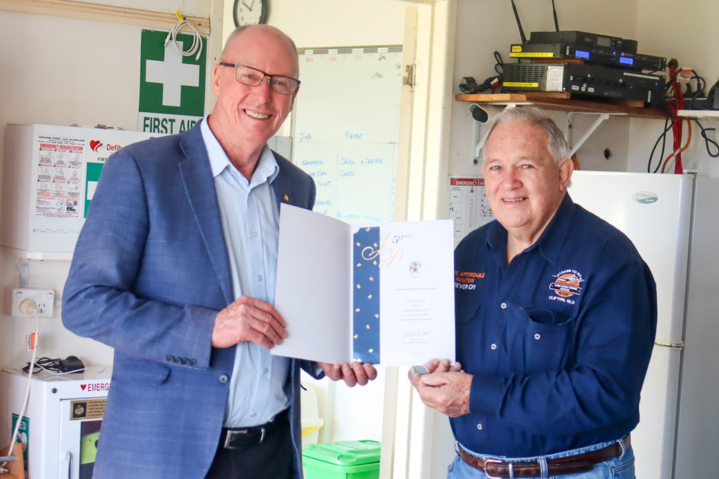 Member for Condamine, Pat Weir visited the Lone Eagle Flying School and presented Trevor Bange with his award for fifty years of service as a Justice of the Peace.