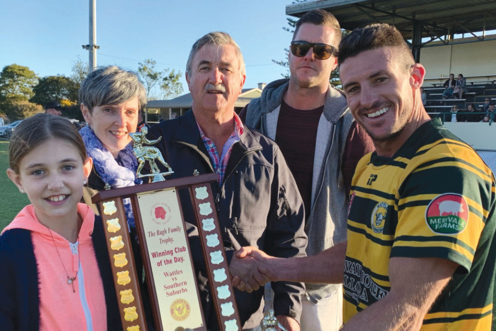 Wattles captain Ryan Duggan receives the Ragh Family Trophy after Wattles win over Souths on Sunday June 13 from Ragh family members Mia, Marie, Dave and Adam.