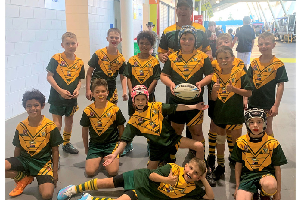 The Wattles Warriors Under 9 team that played Warwick’s Eastern Suburbs Hornets at Cbus Super Stadium on the Gold Coast on Sunday July 30th at half time in the NRL match, won 22 – 13 by the Gold Coast Titans over the North Queensland Cowboys. Back, from left: Thomas Saville, Rhys Gascoyne, Jack Saddlier, Chris Ryan (Coach), Toby Schmidt, Hunter Ryan, Joseph Ramsay, Henry Johnson. Front: Isaac Saddlier, William Erhlich, Heidi Cooper, Maximus Jones and Carter Lyons laying in front.