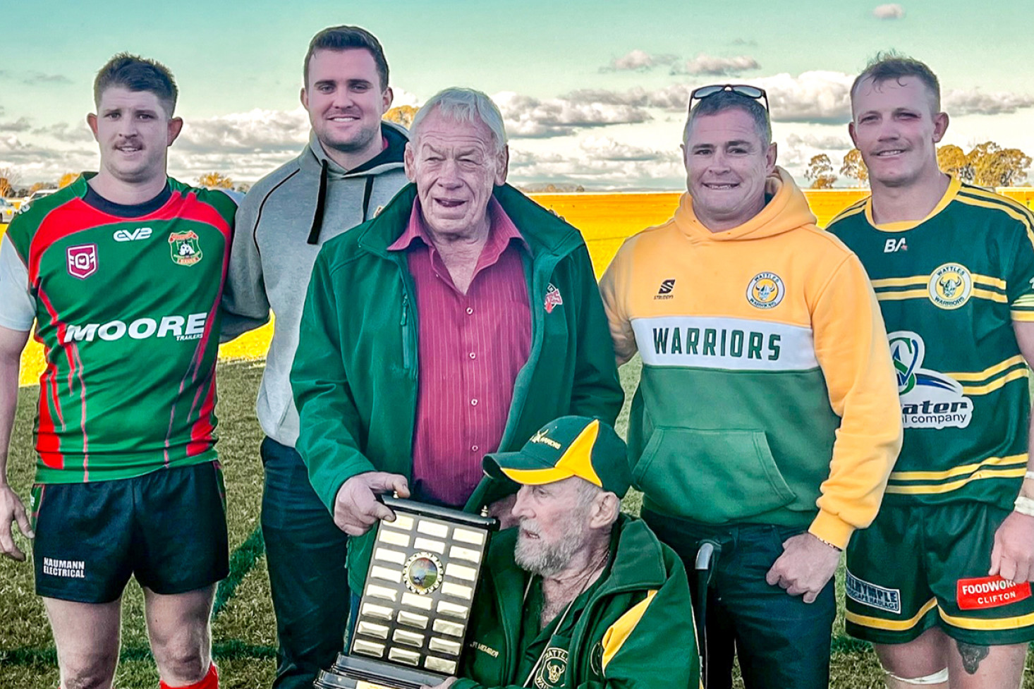 Both the Pittsworth Danes and the Wattles Warriors shared the 2014 Jack Duggan – Gary Sutton Shield after a 12 all result at Clifton on Saturday, from left, Tom O’Sullivan (Pittsworth Co-Captain), James Quinn (Pittsworth Coach), Gary Sutton, Jack Duggan, Travis Burns (Wattles Coach), Nick Van der Poel (Wattles Captain).